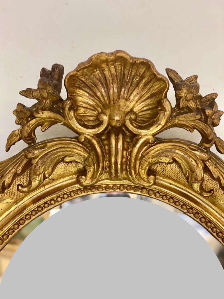 Oval mirror in gold leaf. Lombardy 19th century
