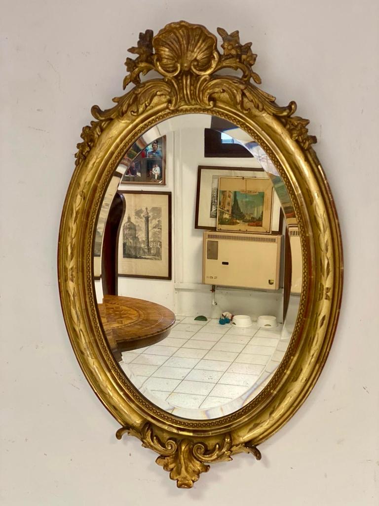 Oval mirror in gold leaf. Lombardy 19th century