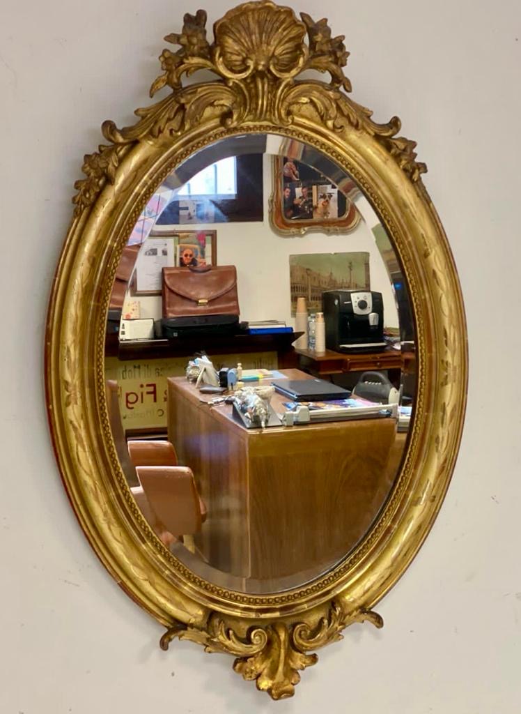 Oval mirror in gold leaf. Lombardy 19th century