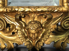 Specchiera a cartoccio in legno intagliato e dorato. Emilia fine XVII secolo