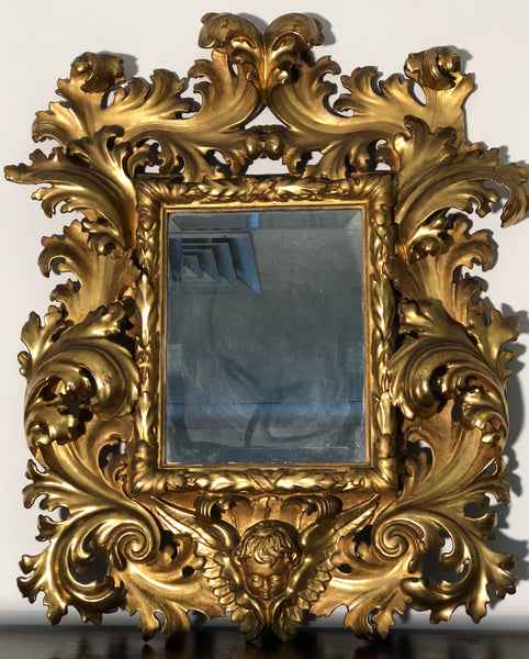 Specchiera a cartoccio in legno intagliato e dorato. Emilia fine XVII secolo
