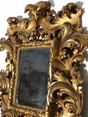 Specchiera a cartoccio in legno intagliato e dorato. Emilia fine XVII secolo
