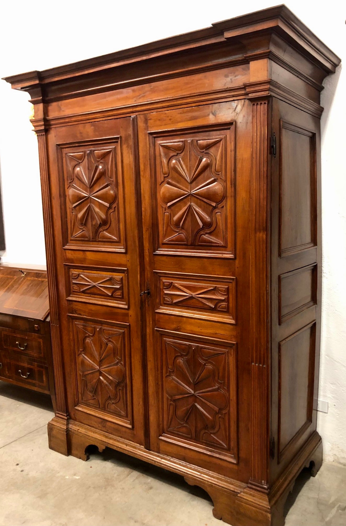 Walnut wardrobe carved with four-leaf clover Genoa late 17th century