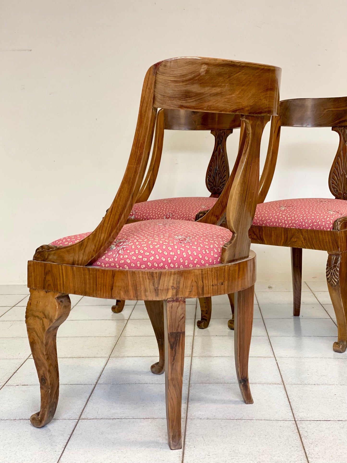 Group of four Empire walnut tub chairs. 19th century