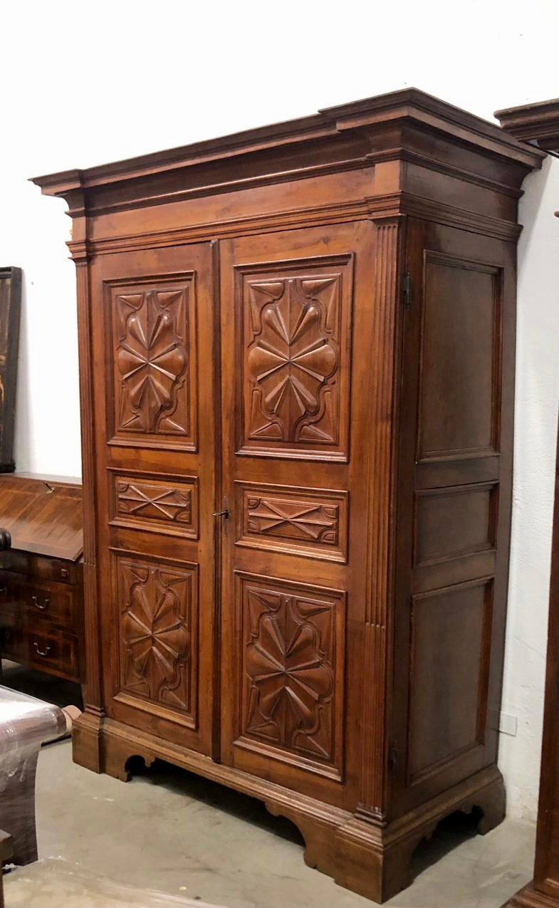 Walnut wardrobe carved with four-leaf clover Genoa late 17th century