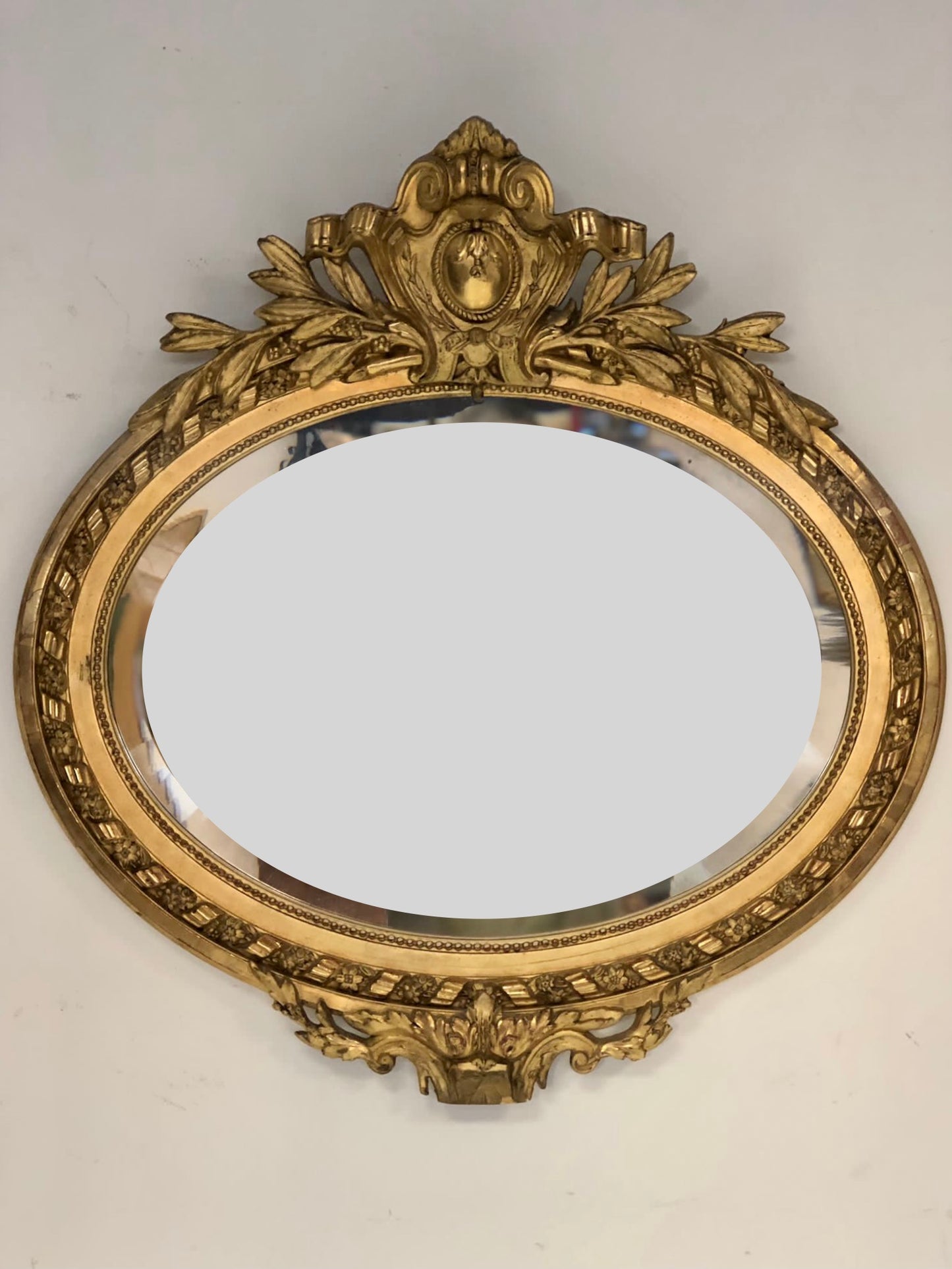 Oval Lombard mirror with coat of arms. 19th century