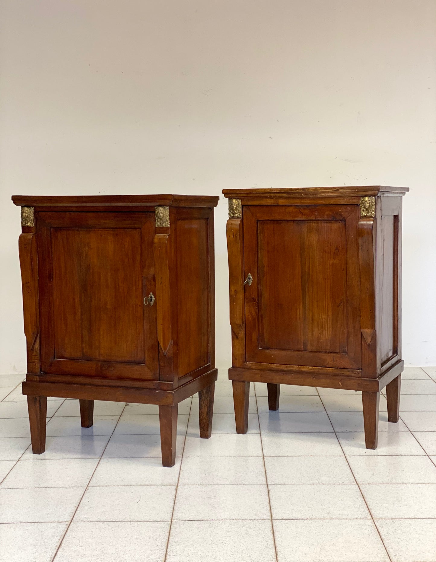 Pair of Empire bedside tables with braces. 19th century