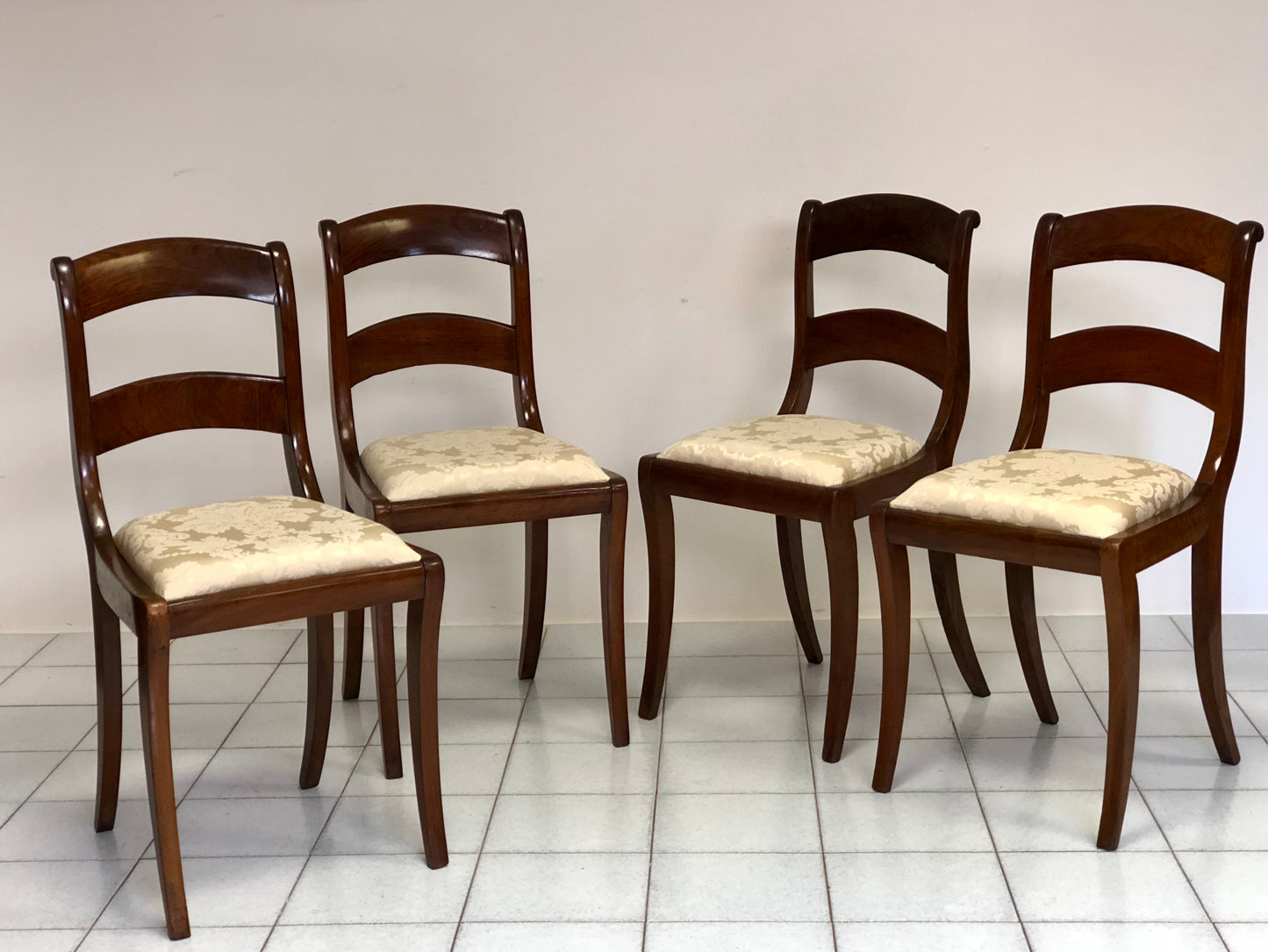 Group of four Emilian Carlo X walnut chairs.