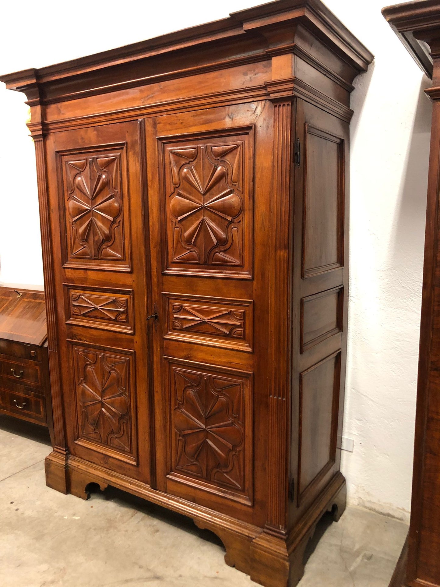 Walnut wardrobe carved with four-leaf clover Genoa late 17th century