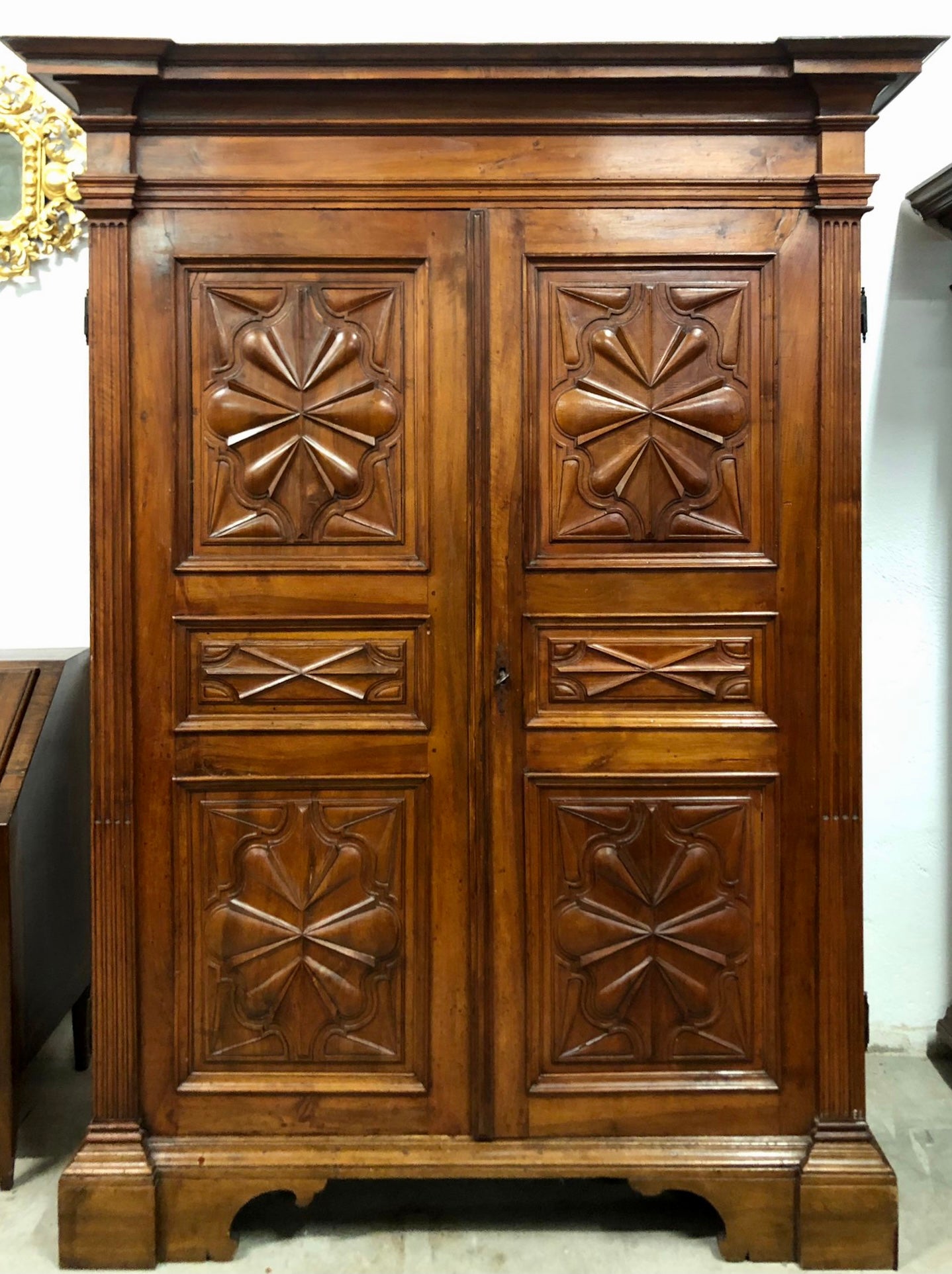 Walnut wardrobe carved with four-leaf clover Genoa late 17th century