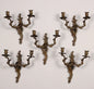 Gruppo di cinque applique a due luci in bronzo.  XIX secolo