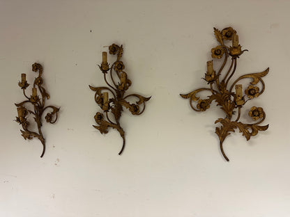 Tre appliques in metallo dorato a motivi floreali.   XIX secolo