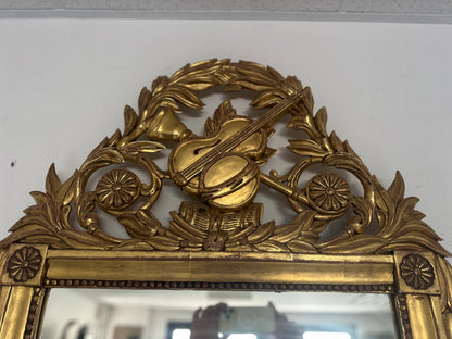 Specchiera in legno intagliato e dorato a foglia.   Toscana epoca impero  prima metà 800