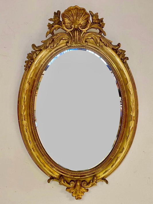 Oval mirror in gold leaf. Lombardy 19th century