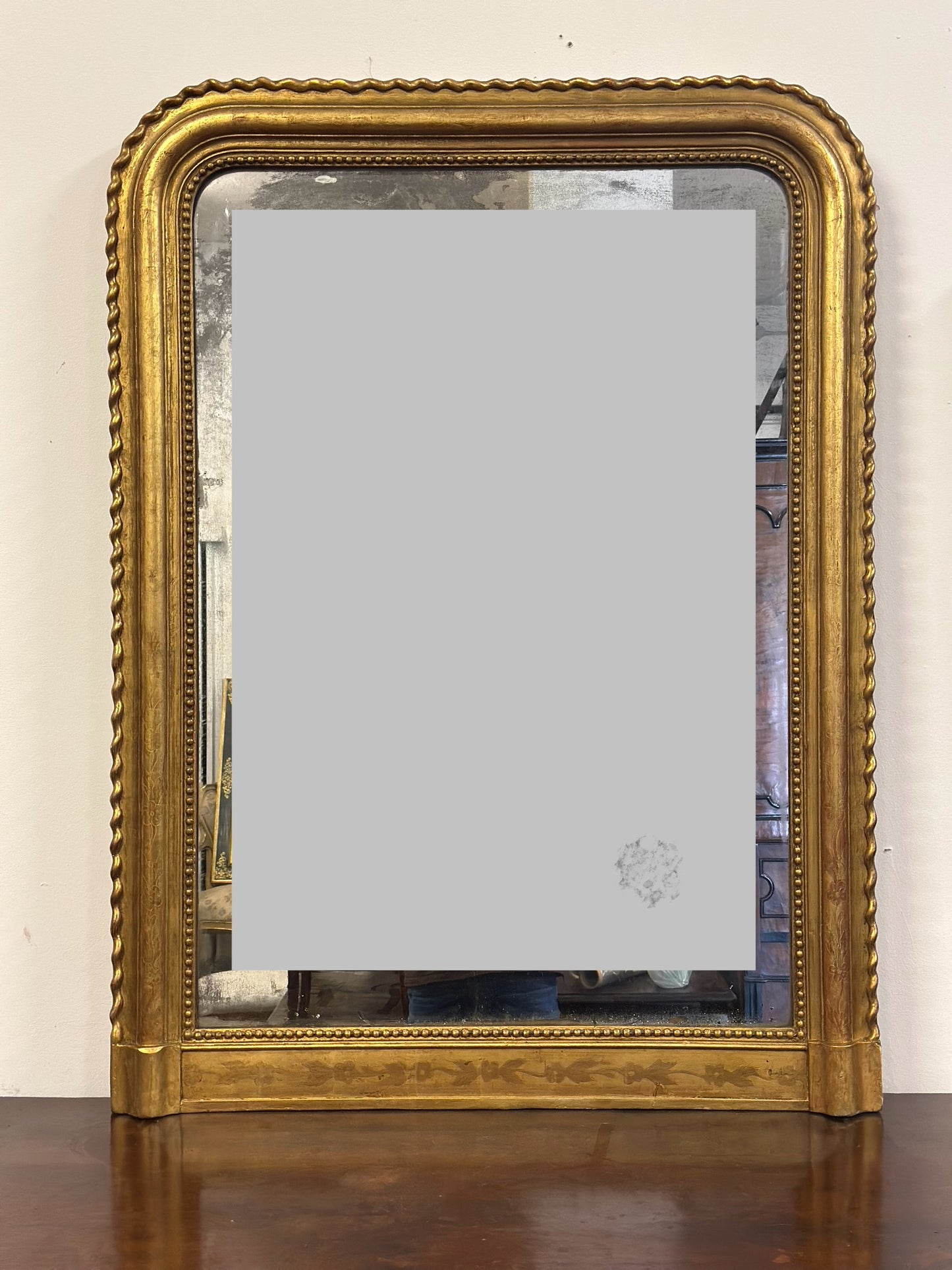Specchiera in legno intagliato dorato con treccia sui lati  XIX secolo