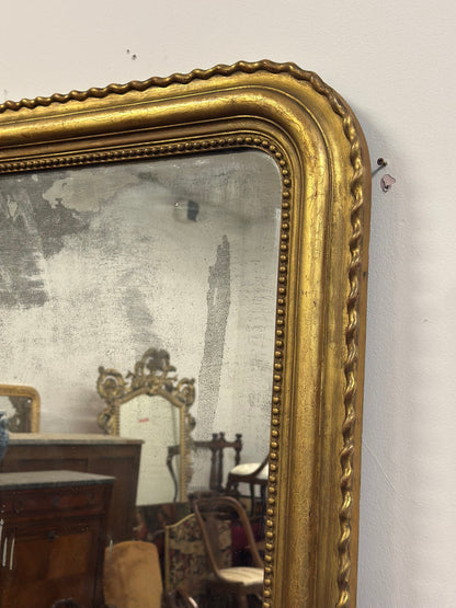 Specchiera in legno intagliato dorato con treccia sui lati  XIX secolo