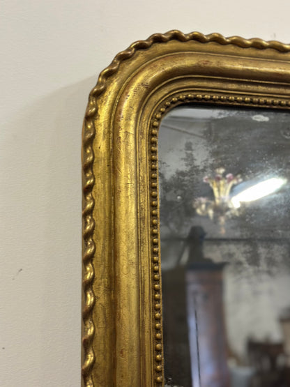 Specchiera in legno intagliato dorato con treccia sui lati  XIX secolo