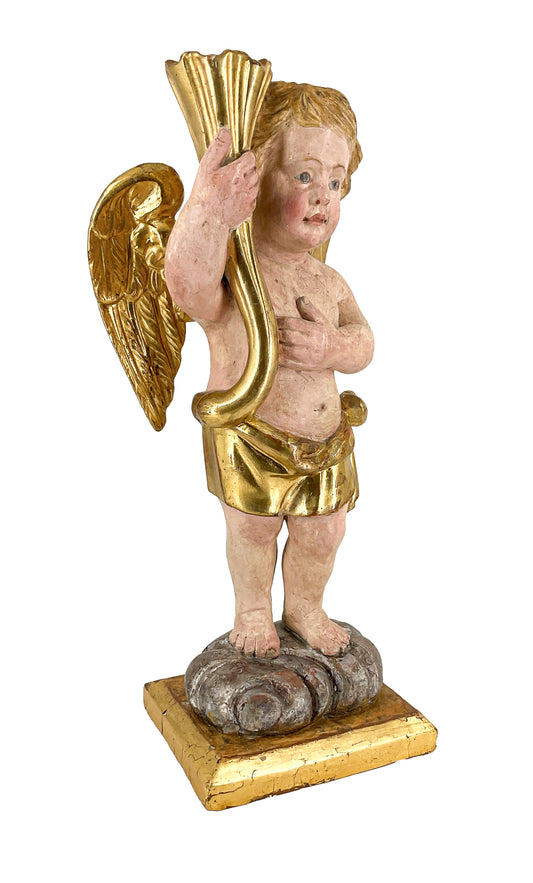 Angelo reggicornucopia in legno intagliato dorato. XVIII secolo.