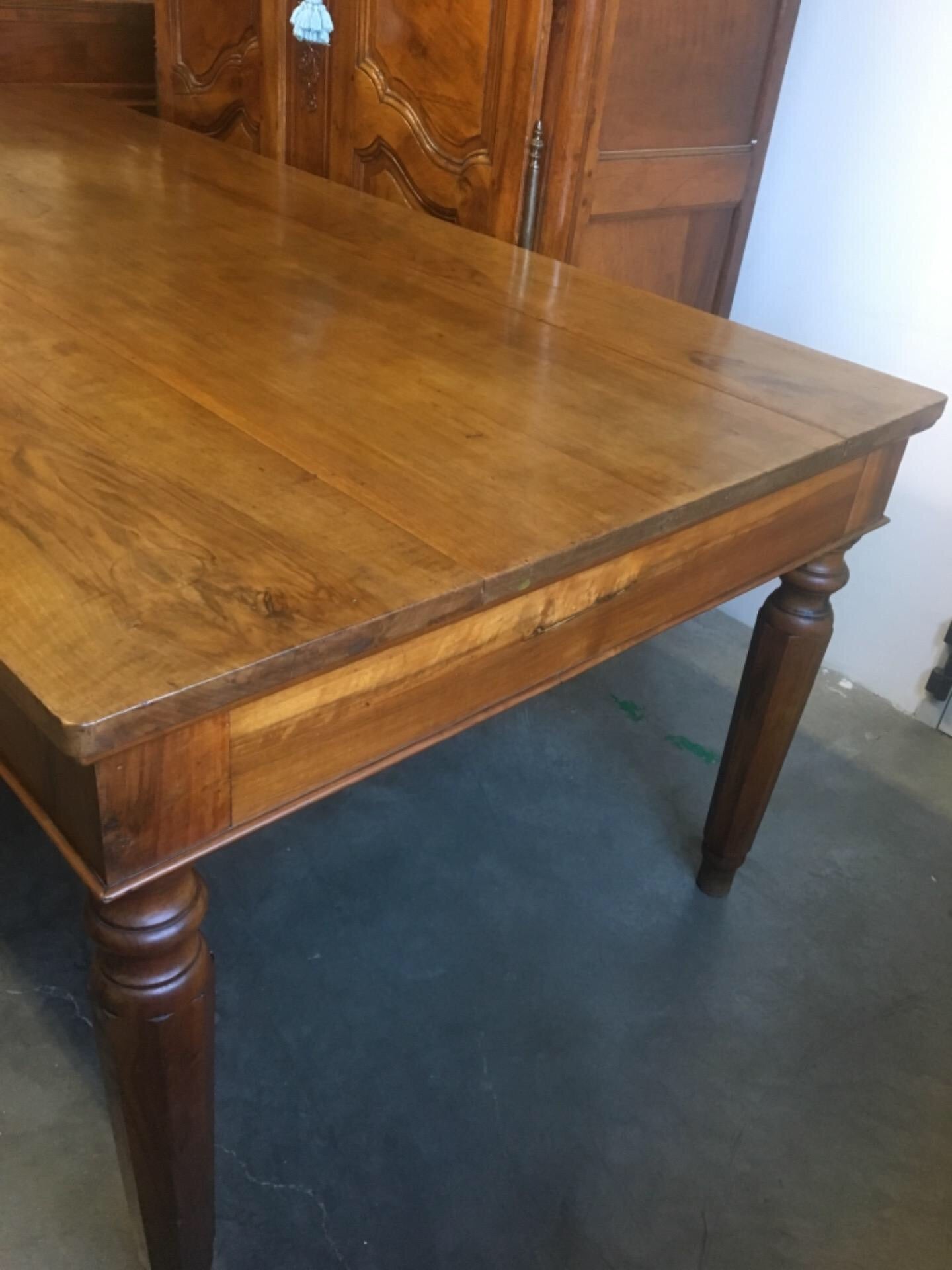 Walnut table from the Charles X era with truncated pyramid legs. 233 X 108