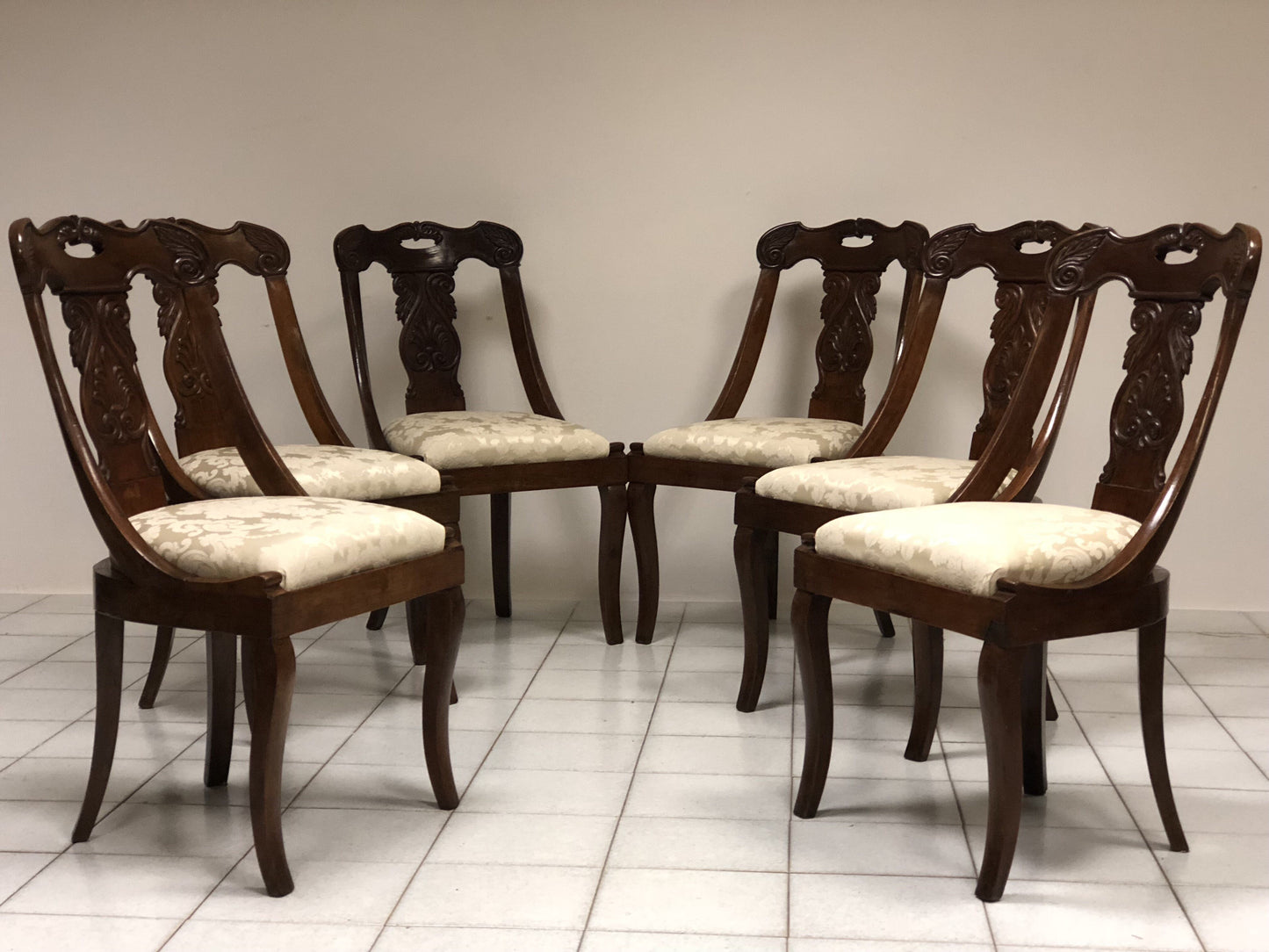 Six walnut gondola chairs. Early 19th century Lombardy