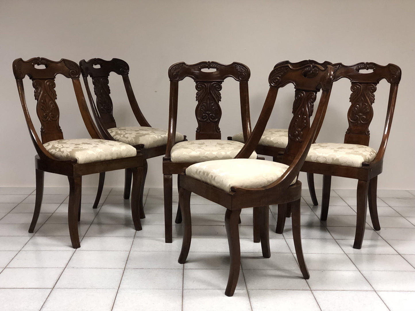 Six walnut gondola chairs. Early 19th century Lombardy