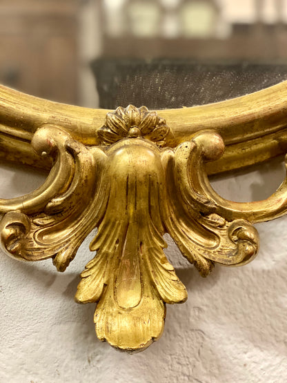 Oval mirror in gold leaf. Lombardy 19th century