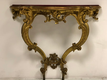 Console carved and gilded in pure gold leaf