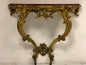 Console carved and gilded in pure gold leaf