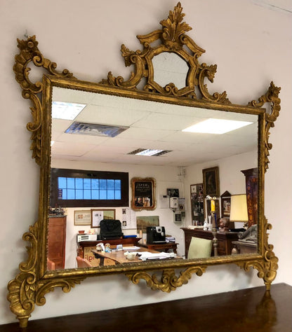 Carved and gilded wooden mirror. Early 20th century