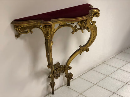 Console carved and gilded in pure gold leaf