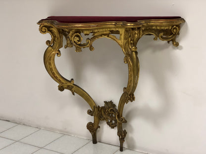 Console carved and gilded in pure gold leaf